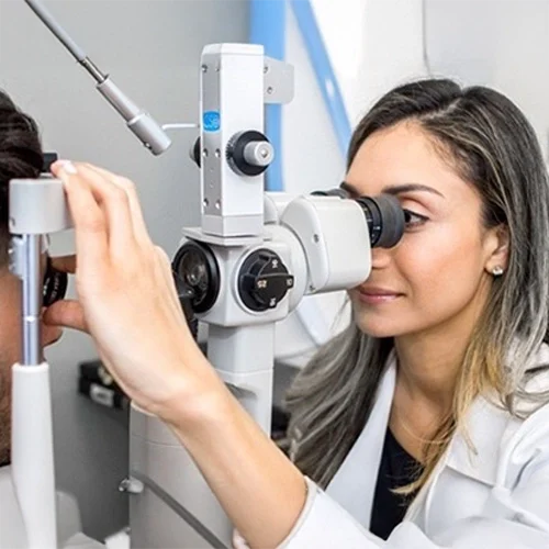 Dr. Balvinder Bharj conducting an eye exam on a patient